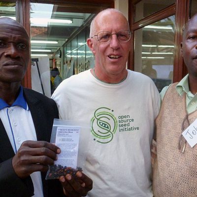 Jack Kloppenburg (OSSI, USA) shares OSSI-Pledged seed (Beefy Resilient Grex beans, bred by Carol Deppe) with Ugandan farmer Geoffrey Mugarura and John Mulumba (Plant Genetic Resources Center, Uganda)